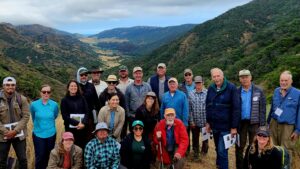 Group Photo (partial) The UC Field Station is in the Central Valley in the background with Valley Anchorage at the eastern end of the Central Valley. The group (from left to right): Lauren Morris, Andrew Martinez, Siomara Zendejas, Terry Cook, Rebecca Lybrand (front row, kneeling); Miguel Ramos, Taylor Cullum-Muyres, Maripaula Valdes-Berriz, Madison Morris, Cassandra Collins, Ron Taskey, Julie Baker, Jim Regal, James Frampton, Dennis Fenwick (middle); D. Ryan Dodd, Bryan Rahn, Christopher D'Aiuto, Beau Antongiovanni, David Smith, Kerry Arroues, Jan Weston (back). (Photo courtesy of David W. Smith)